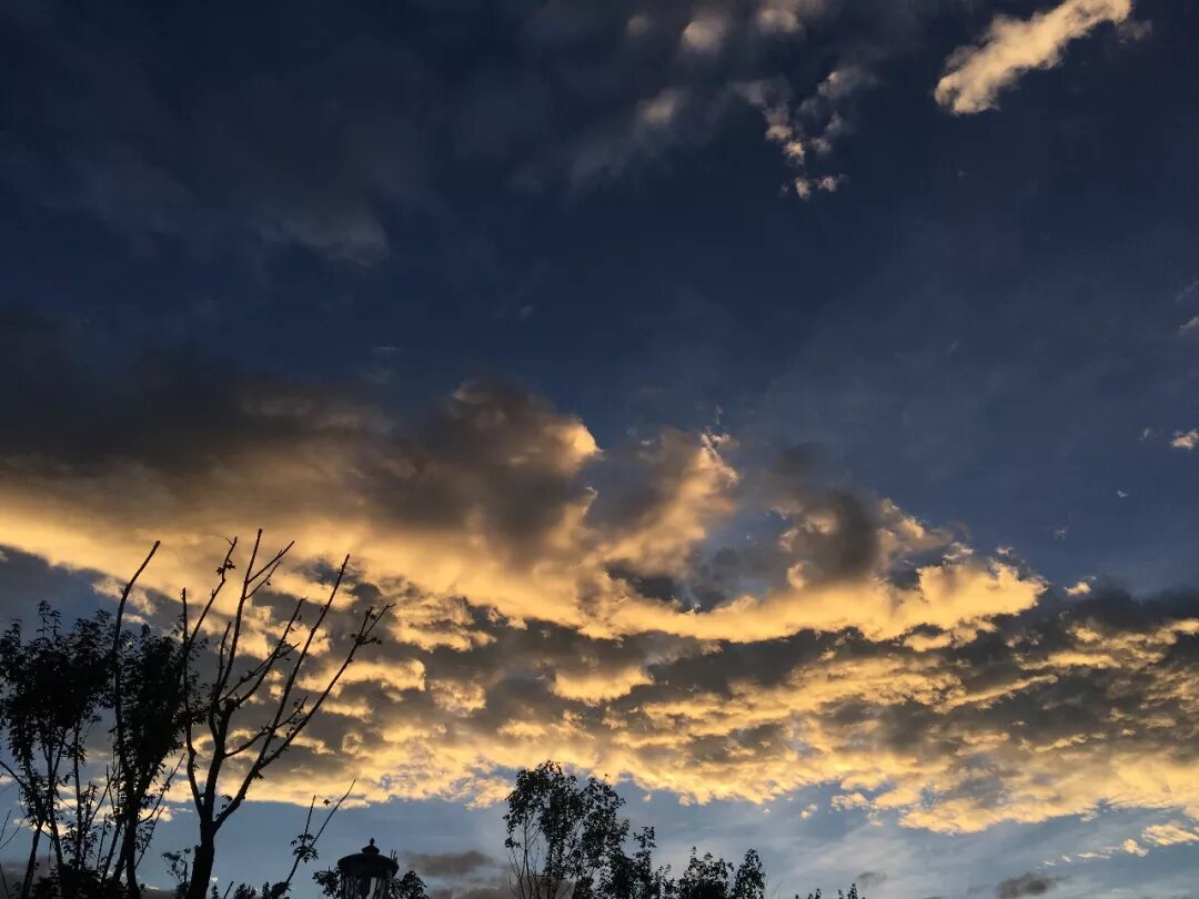 Sunlight breaking through dark clouds above Shaxi