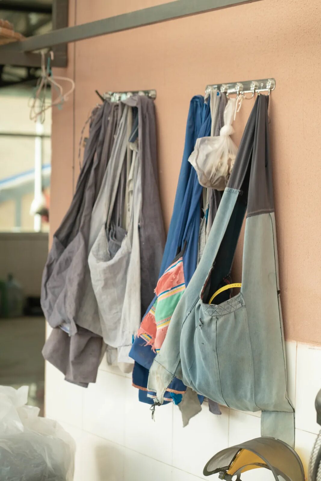 Work aprons hanging in the tea-making space