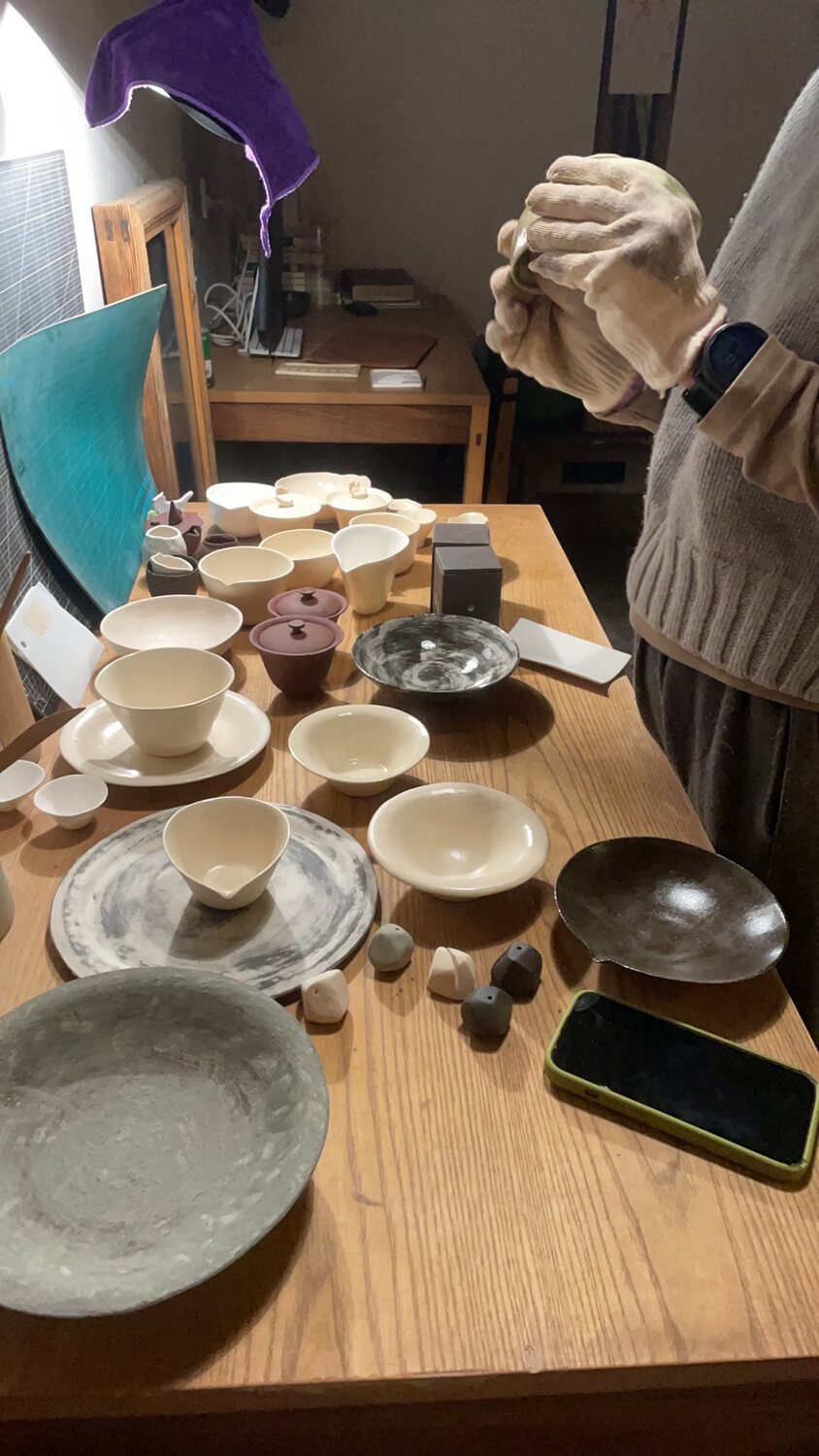 A worktable filled with Luo Bo’s finished pottery